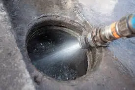 A fuel nozzle dispensing liquid into an open fuel tank or reservoir.
